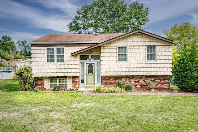 split foyer home with a front lawn