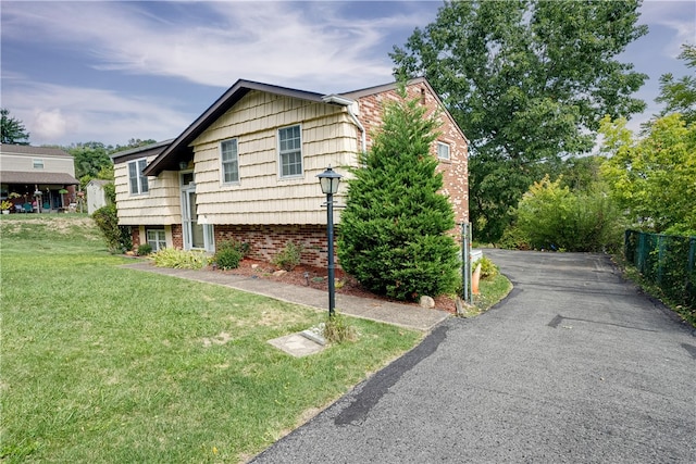 view of side of home featuring a yard