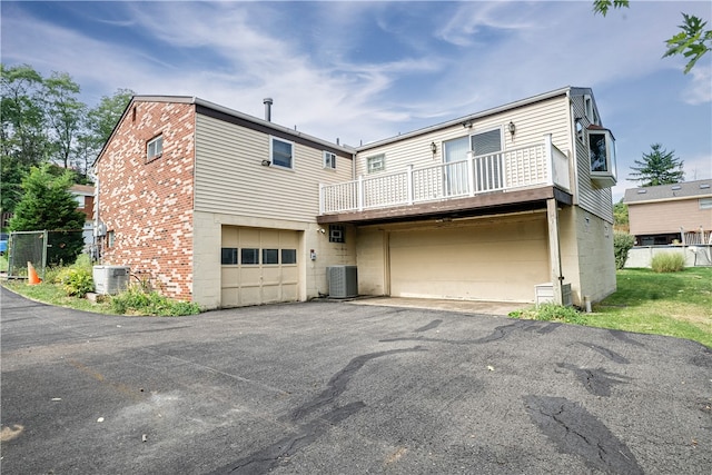 exterior space with cooling unit and a garage