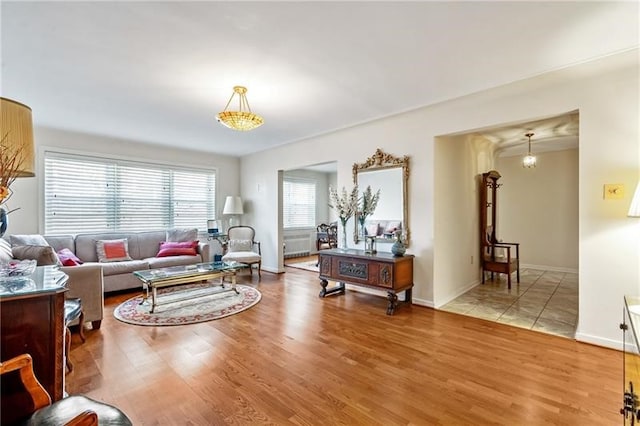 living room with wood-type flooring and a chandelier