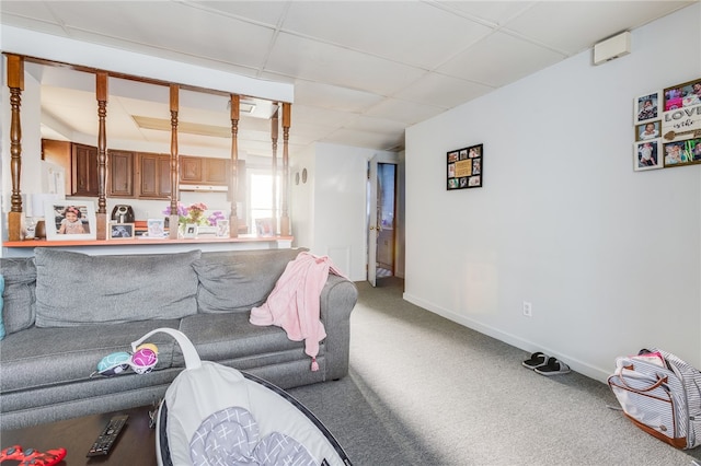 living room with carpet and a drop ceiling