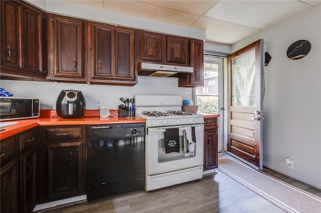 kitchen featuring dishwasher, dark brown cabinets, white gas range, and light hardwood / wood-style floors