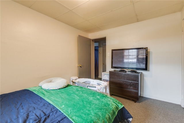 carpeted bedroom with a paneled ceiling