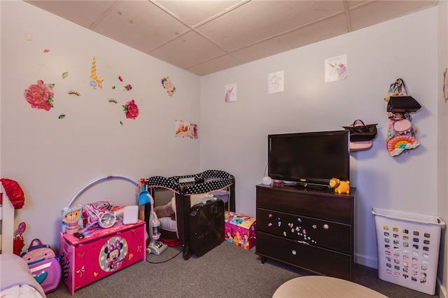 carpeted bedroom featuring a drop ceiling