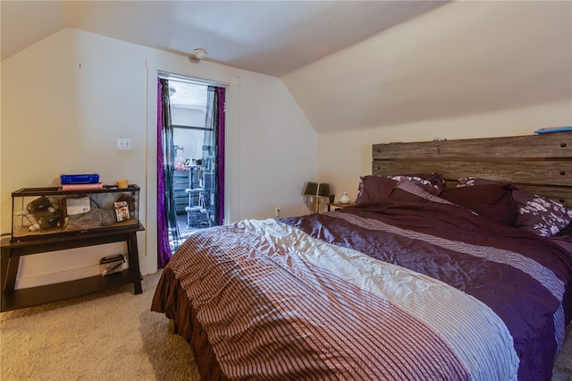 bedroom featuring light colored carpet and vaulted ceiling