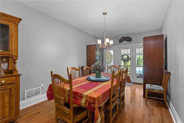 dining room with an inviting chandelier and hardwood / wood-style floors