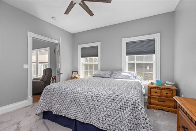 bedroom with ceiling fan and light colored carpet