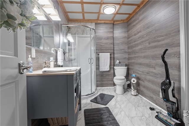 bathroom with vanity, toilet, and a shower with door