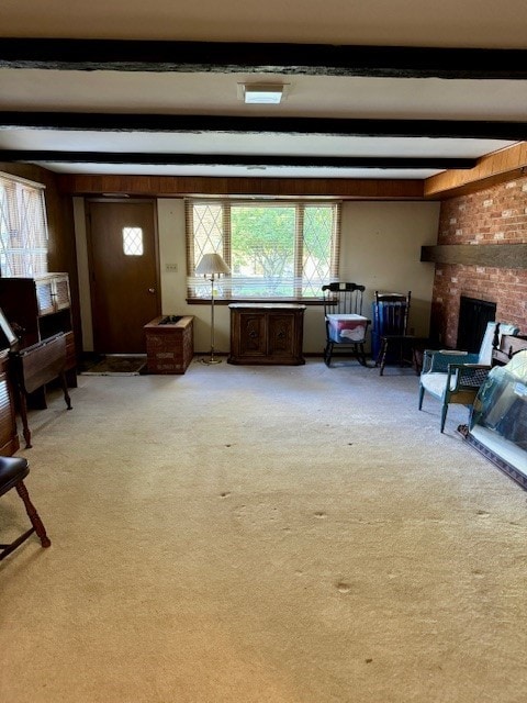 living room featuring light carpet, beam ceiling, and a fireplace