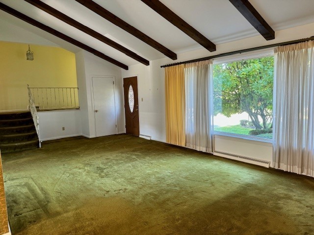 interior space with vaulted ceiling with beams and dark colored carpet