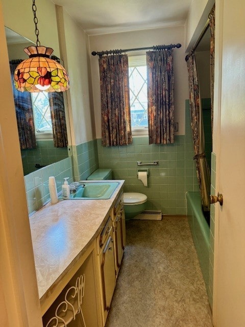 bathroom featuring vanity, toilet, and tile walls