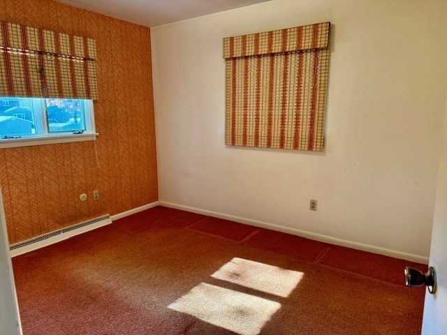 unfurnished room with carpet floors and baseboard heating