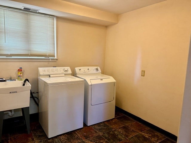 washroom featuring independent washer and dryer and sink