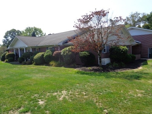 view of side of property with a yard