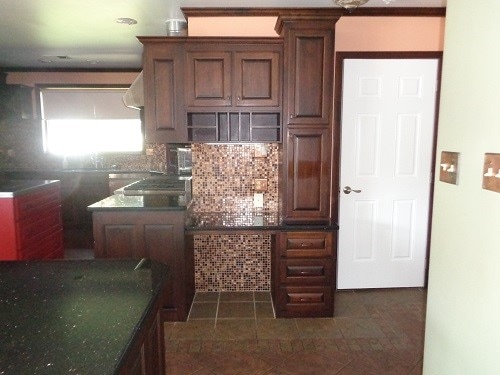 kitchen with backsplash and dark tile patterned floors