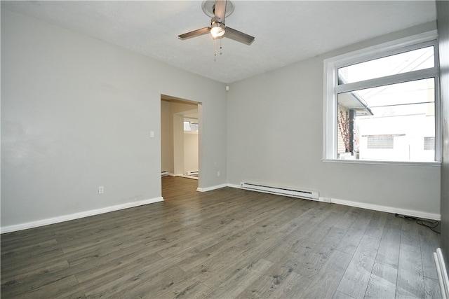 empty room with dark hardwood / wood-style flooring, a baseboard radiator, and ceiling fan