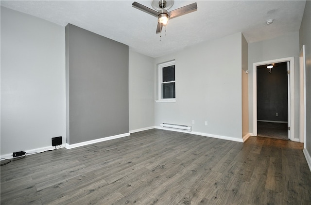 empty room featuring ceiling fan, baseboard heating, dark hardwood / wood-style flooring, and a textured ceiling