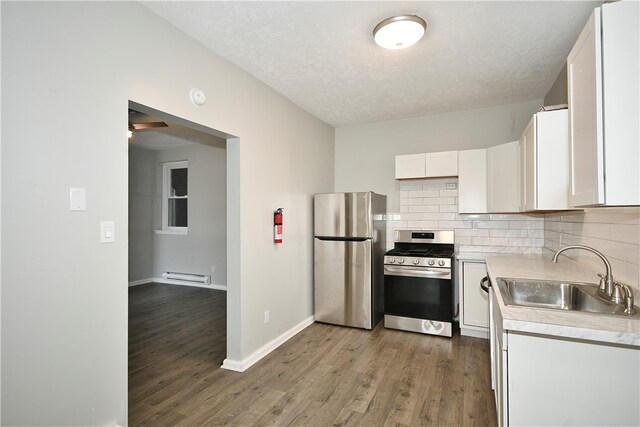 kitchen featuring appliances with stainless steel finishes, hardwood / wood-style flooring, sink, and white cabinets