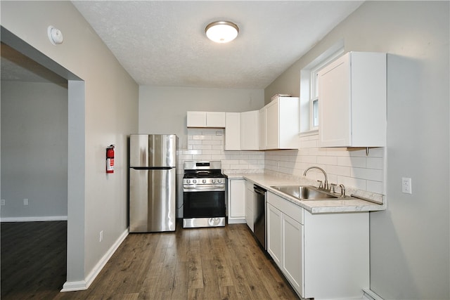 kitchen with white cabinets, appliances with stainless steel finishes, and sink