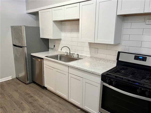 kitchen featuring dark wood-type flooring, stainless steel appliances, sink, and white cabinetry