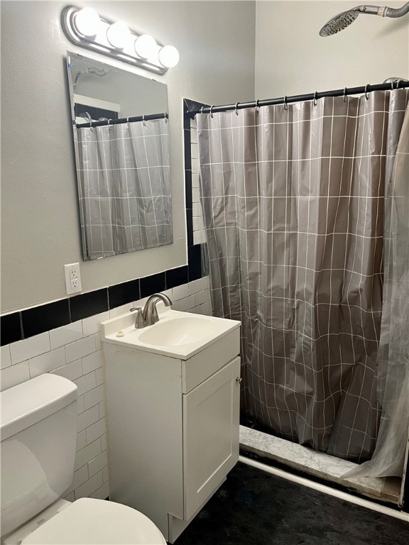 bathroom featuring curtained shower, tile walls, toilet, and vanity