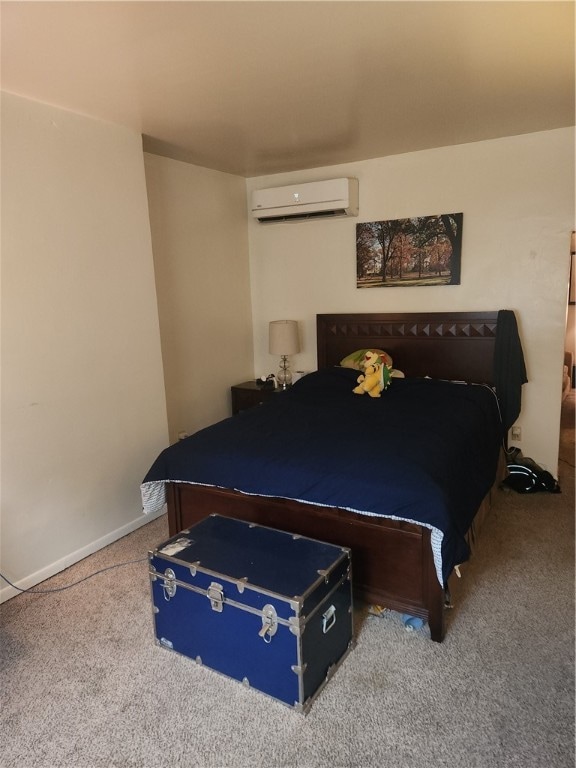 carpeted bedroom featuring a wall unit AC