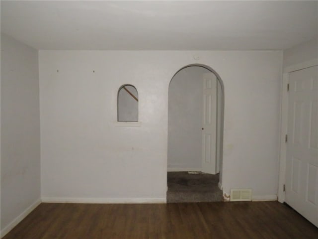 empty room featuring dark hardwood / wood-style flooring