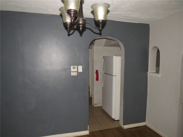 corridor with wood-type flooring