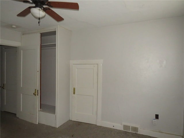 unfurnished bedroom with carpet, ceiling fan, and a closet