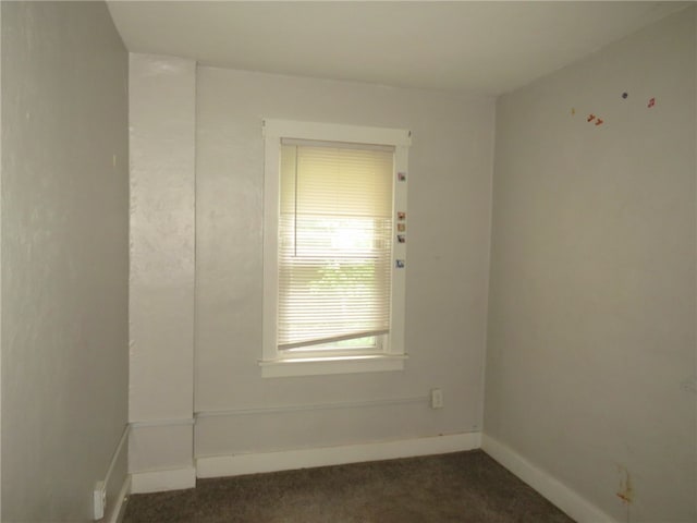 empty room featuring dark colored carpet