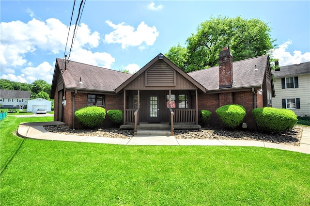 view of front of property featuring a garage, a porch, and a front lawn