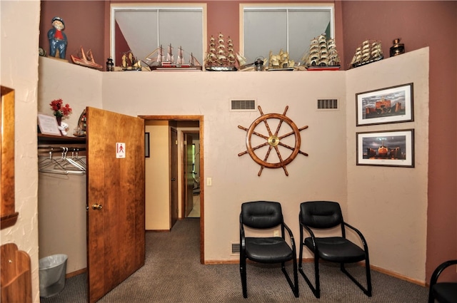 interior space with a towering ceiling and carpet flooring