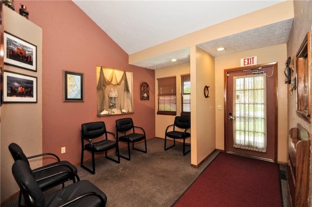 entryway with dark carpet and vaulted ceiling