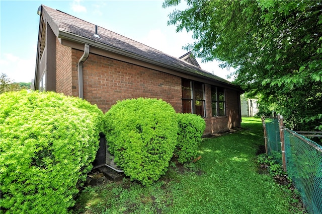 view of side of home featuring a yard