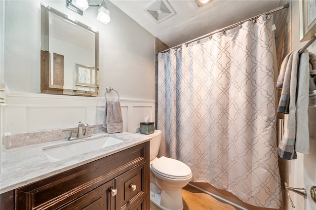 bathroom featuring vanity, a shower with shower curtain, toilet, hardwood / wood-style flooring, and lofted ceiling