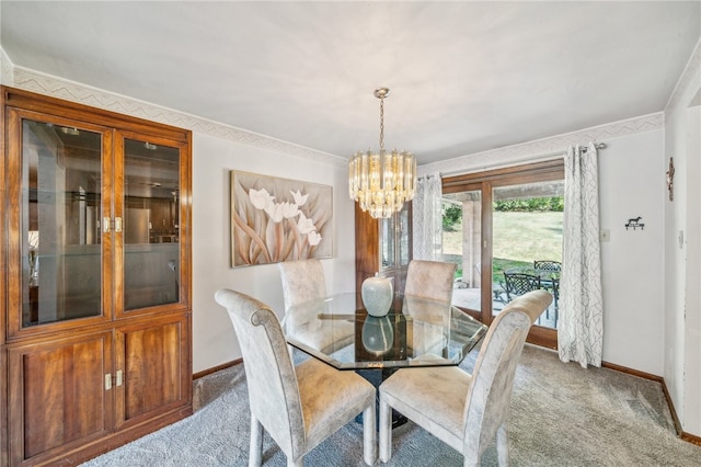 dining room featuring carpet, a chandelier, and crown molding