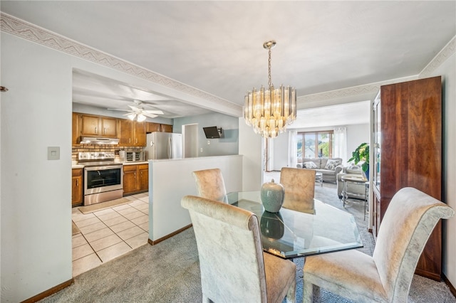 dining area featuring light tile patterned floors and ceiling fan with notable chandelier