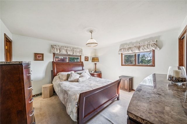 bedroom featuring multiple windows and light colored carpet