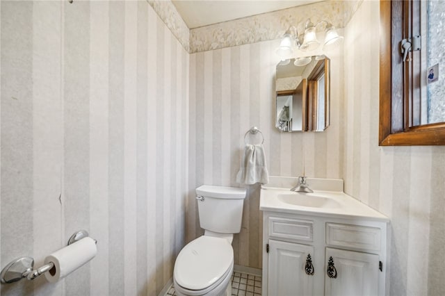 bathroom with vanity, toilet, and tile patterned flooring