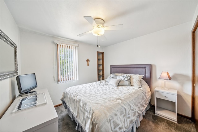 bedroom featuring dark carpet and ceiling fan