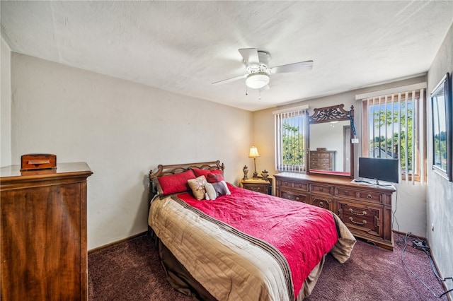 bedroom featuring ceiling fan and dark colored carpet