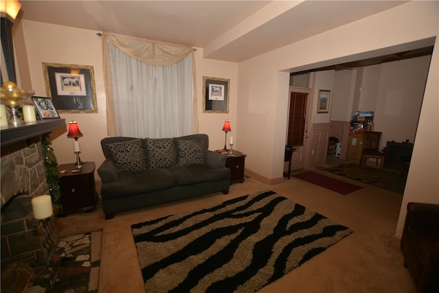 living room with carpet flooring and a stone fireplace