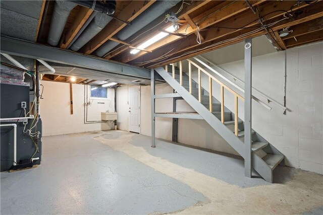 basement featuring heating unit and sink