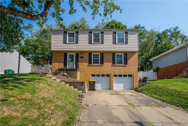 view of front of home with a front lawn and a garage