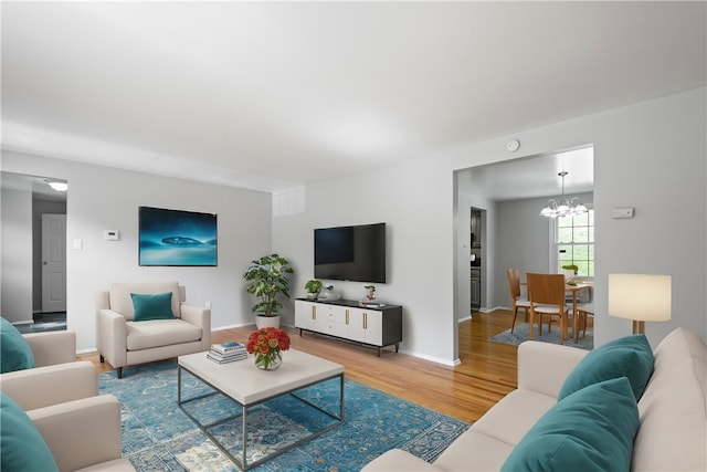 living room with an inviting chandelier and wood-type flooring