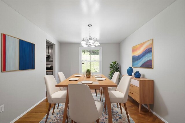 dining room with a notable chandelier and hardwood / wood-style flooring