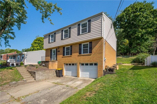 view of front of property featuring a garage and a front lawn