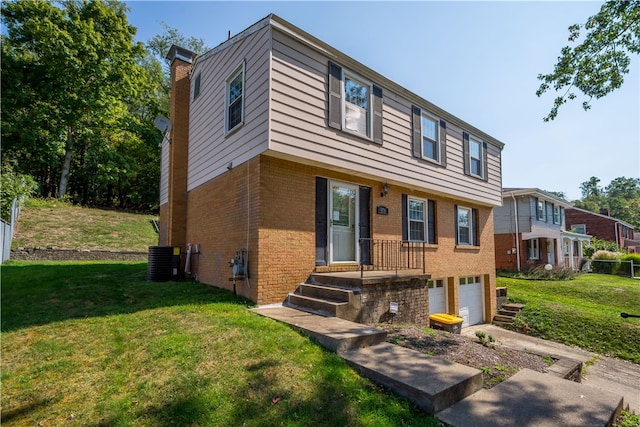 view of front of house featuring a front lawn, central air condition unit, and a garage