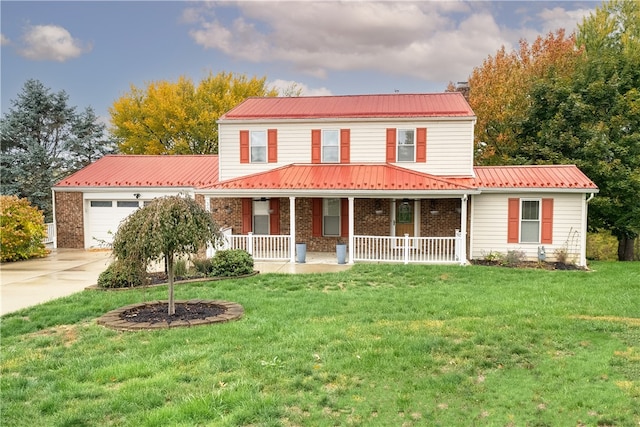 view of front of house with covered porch, a front lawn, and a garage