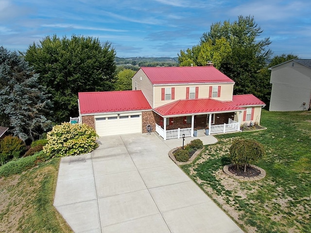 view of front of home featuring a front yard, an outdoor structure, a garage, and a porch